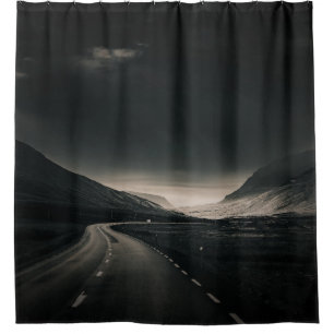 BLACK ASPHALT ROAD NEAR MOUNTAIN DURING DAYTIME