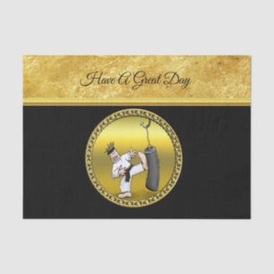 Black belt karate man kicking a black training bag tissue paper