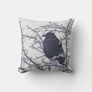 Black bird between snowy branches throw pillow