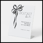 Black Bow Watercolor Bridal Shower Bouquet Bar Pedestal Sign<br><div class="desc">A bridal shower should be as elegant as it is unforgettable. This Bouquet Bar sign invites guests to take home a piece of the celebration by crafting their own floral arrangement. With its delicate hand-painted black ribbon and refined typography, this piece adds an effortless touch of sophistication, elevating the experience...</div>