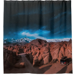 BLACK CAR NEAR ROCK FORMATIONS
