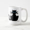 Black Cat with Blue Eyes Sitting Staring