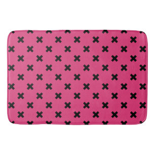 Black cross stitches on fuchsia bath mat