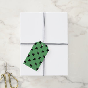 Black cross stitches on green gift tags