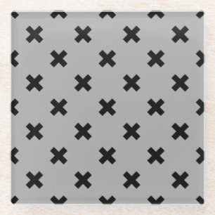 Black cross stitches on grey glass coaster