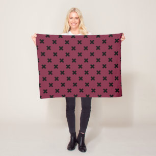 Black cross stitches on mulberry fleece blanket