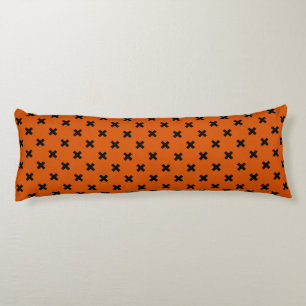 Black cross stitches on orange body pillow