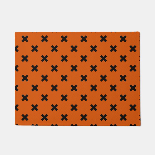 Black cross stitches on orange doormat (Front)