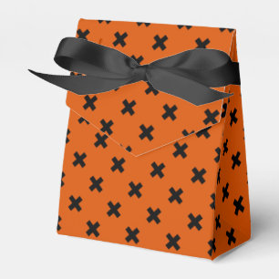Black cross stitches on orange favor box