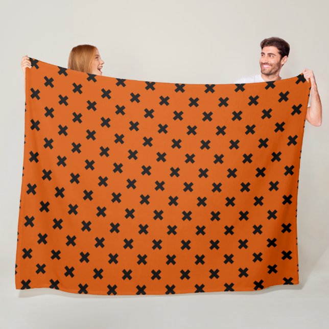 Black cross stitches on orange fleece blanket (In Situ)