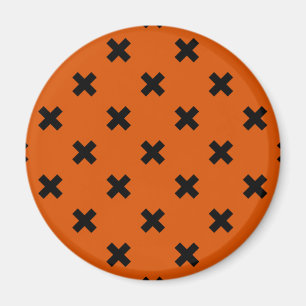 Black cross stitches on orange magnet