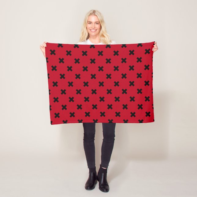 Black cross stitches on red fleece blanket (In Situ)