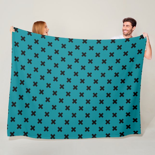 Black cross stitches on teal fleece blanket (In Situ)