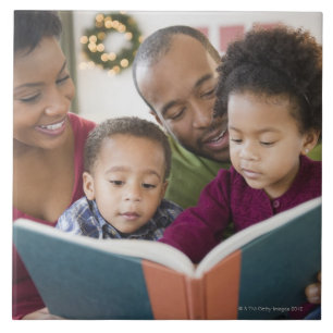 Black family reading book together tile