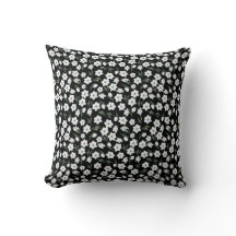 Black floral throw pillow with white flowers