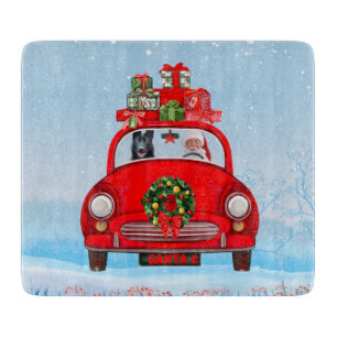 Black German Shepherd Dog In Car With Santa Claus  Cutting Board
