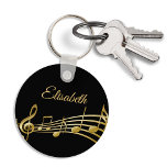 Black gold music notes monogram name keychain<br><div class="desc">Simple and elegant for a music lover! Black background with faux gold music notes. Template for your name,  golden hand lettered style script.</div>