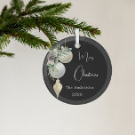 Black gold white baubles Christmas Glass Ornament<br><div class="desc">An elegant,  modern black background. Decorated with white and gold baubles and some greenery and a pine cone.  Personalize and add your name,  year.  Text: Merry Christmas</div>