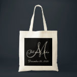 Black Grey Elegant Monogram Wedding Tote Bag<br><div class="desc">Elegant Monogram Wedding Tote Bags. Design by Elke Clarke © 2008 for MonogramGallery at Zazzle. Black and white with grey initial text overlay with bride and groom names and wedding date. Great destination wedding guest bag,  wedding gift,  wedding keepsake or wedding favour.</div>