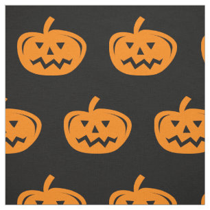 Black Halloween fabric with carved orange pumpkins