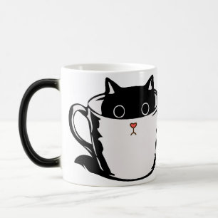 Black kitten with red nose hiding in a cup