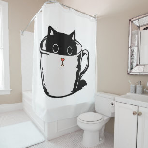 Black kitten with red nose hiding in a cup