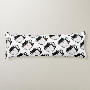 Black kitten with red nose hiding in a cup body pillow