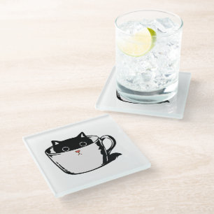 Black kitten with red nose hiding in a cup glass coaster