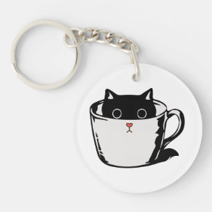 Black kitten with red nose hiding in a cup keychain