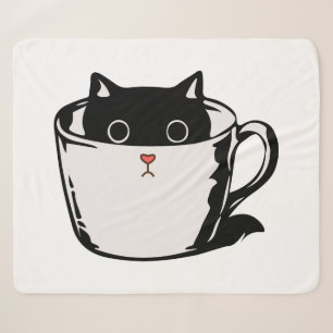 Black kitten with red nose hiding in a cup sherpa blanket