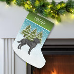 Black Labrador Retriever Winter Forest Custom Name Small Christmas Stocking<br><div class="desc">Destei's original cartoon illustration of a cute black Labrador Retriever breed dog. The dog is placed in a winter scene with three green fir trees and falling snow. The background is a blue to white gradient giving the design that cold winter day look. There is also a green gradient line...</div>