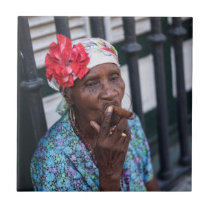 Black lady smoking a cigar with flower on head tile