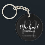 Black Modern Script Personalized Groomsmen Keychain<br><div class="desc">Add a personal touch to your wedding with personalized groomsmen keychain. This keychain features personalized groomsmen's name in white modern script font style and monogram in grey modern script font style as background with title and wedding date in white modern sans serif font style on black background. Also perfect for...</div>