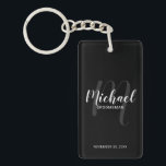 Black Modern Script Personalized Groomsmen Keychain<br><div class="desc">Add a personal touch to your wedding with personalized groomsmen keychain. This keychain features personalized groomsmen's name in white modern script font style and monogram in light grey modern script font style as background with title and wedding date in white modern sans serif font style on black background. Also perfect...</div>