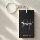 Black Modern Script Personalized Groomsmen Keychain<br><div class="desc">Add a personal touch to your wedding with personalized groomsmen keychain. This keychain features personalized groomsmen's name in white modern script font style and monogram in light grey modern script font style as background with title and wedding date in white modern sans serif font style on black background. Also perfect...</div>