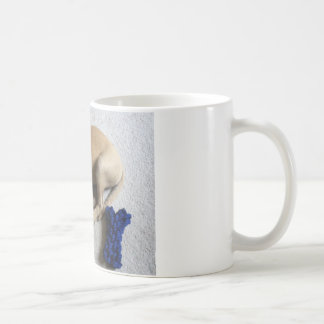 Black-mouth cur puppy with blue toy coffee mug