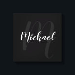 Black personalized Monogram and Name Canvas Print<br><div class="desc">Personalized Monogram and Family Name Gift
featuring name in white modern script font style and monogram in grey modern script font style as background on black background.</div>