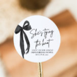Black Pink Bow She's Tying the Knot Bridal Shower Classic Round Sticker<br><div class="desc">Add a stylish touch to your bridal shower favours with our Black Pink Bow She's Tying the Knot Bridal Shower Classic Round Sticker! Featuring a chic black design with a feminine pink bow, this elegant sticker is perfect for sealing envelopes, decorating gift bags, or adding a personal touch to your...</div>