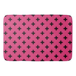 Black polka crosses on fuchsia bath mat