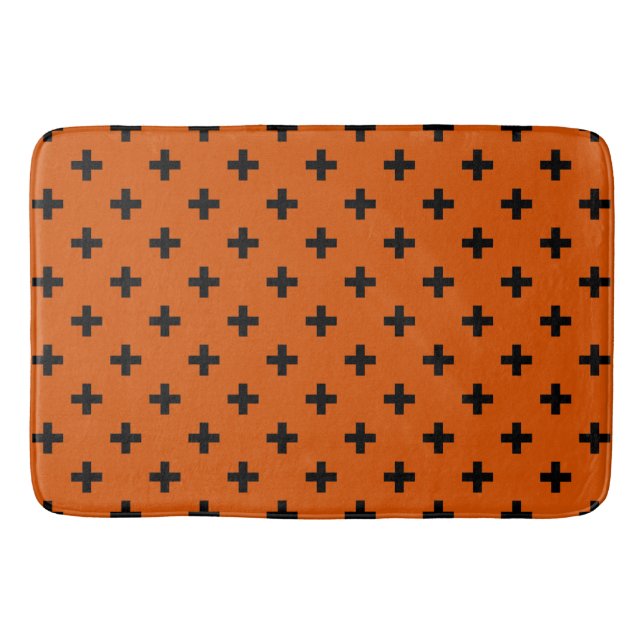 Black polka crosses on orange bath mat (Front)