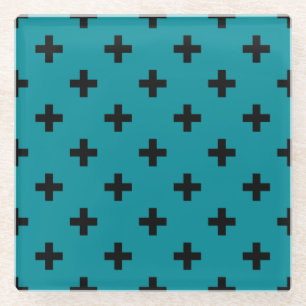 Black polka crosses on teal glass coaster