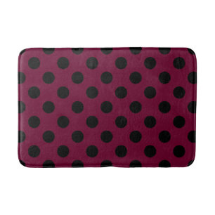 Black polka dots on burgundy bath mat