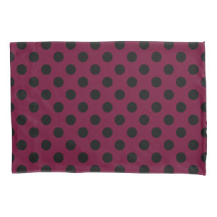 Black polka dots on burgundy pillowcase