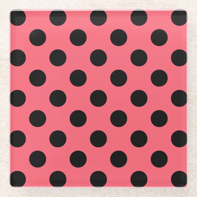 Black polka dots on coral glass coaster (Front)
