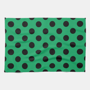 Black polka dots on fresh green kitchen towel