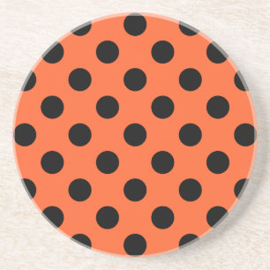 Black polka dots on orange coaster
