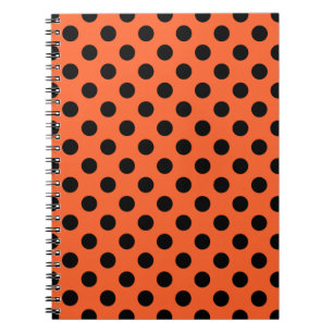 Black polka dots on orange notebook