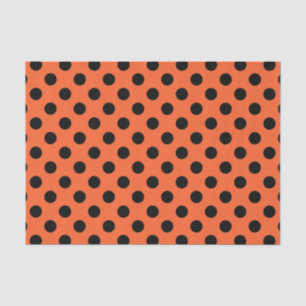 Black polka dots on orange tissue paper