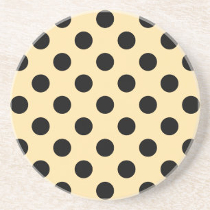 Black polka dots on pale yellow coaster