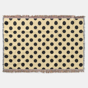 Black polka dots on pale yellow throw blanket